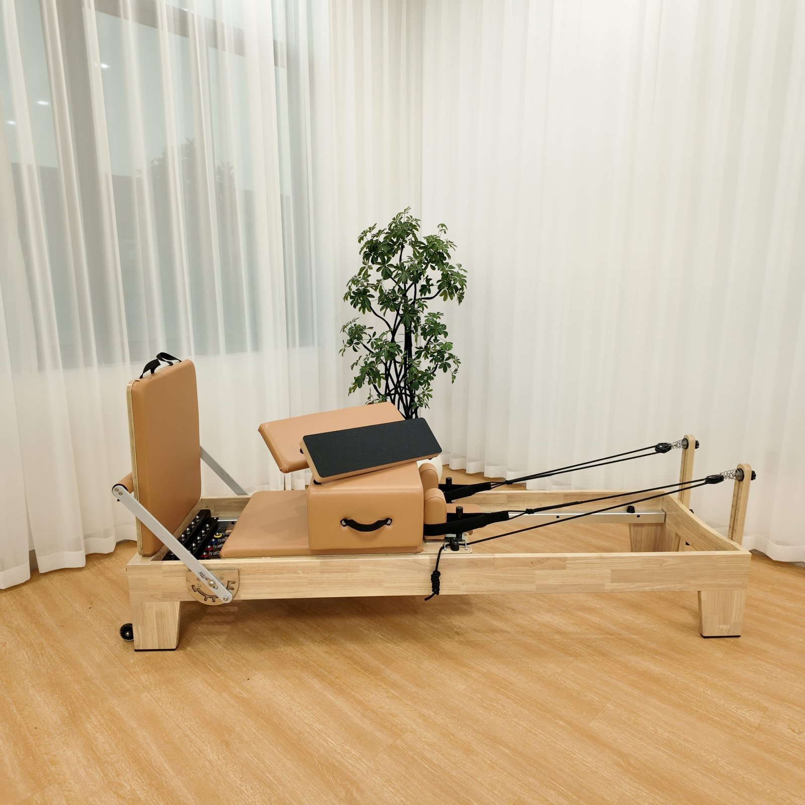 Front view of solid oak Pilates Reformer for studio use