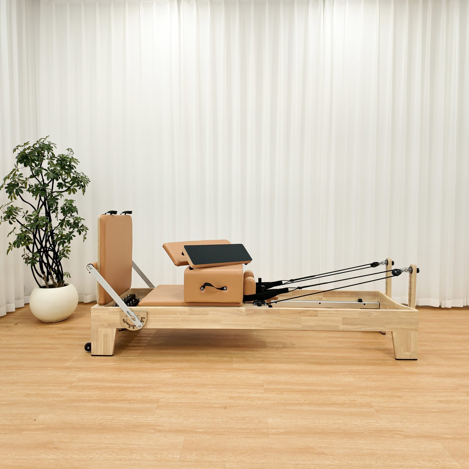 Front view of solid oak Pilates Reformer for studio use