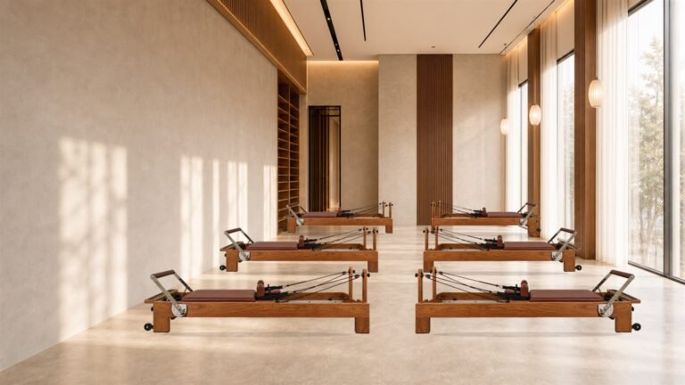commercial Pilates studio with reformers arranged in organized training rows